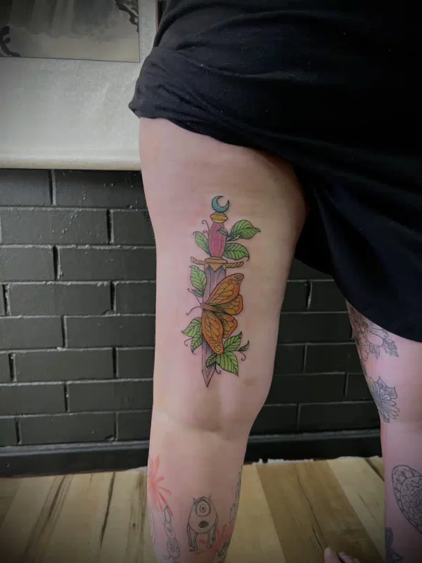 Colorful flower tattoo on a leg